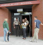 Briefing victims at the door.