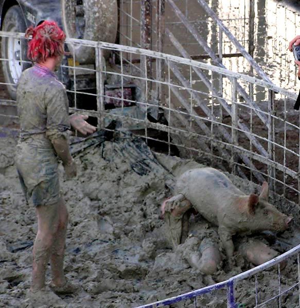 Girl holding up the pig. Photo by Pinedale Online.