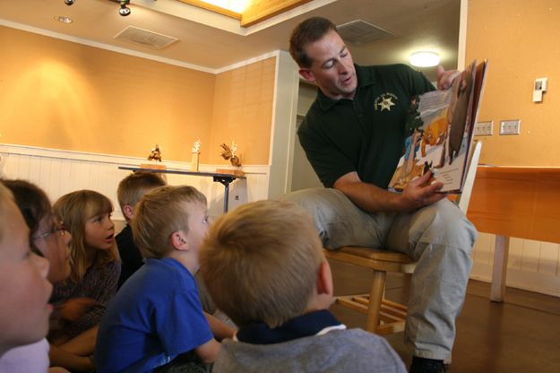 Officer Lehr reading . Photo by Pam McCulloch.