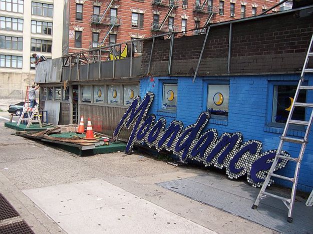 Taking the sign down. Photo by John Moore.