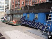 Taking the sign down. Photo by John Moore.