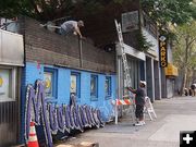 Taking it down. Photo by John Moore.