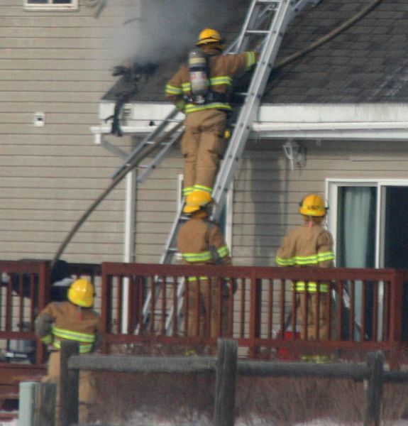 Getting hoses up. Photo by Clint Gilchrist, Pinedale Online.