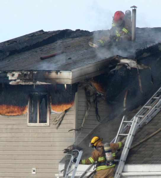 Working on the roof. Photo by Clint Gilchrist, Pinedale Online.