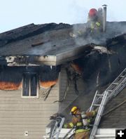 Working on the roof. Photo by Clint Gilchrist, Pinedale Online.