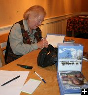 Signing books. Photo by Dawn Ballou, Pinedale Online.