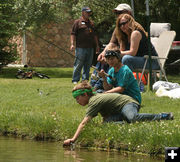 Releasing his fish. Photo by Dawn Ballou, Pinedale Online.