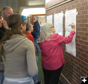 Posting scores. Photo by Bill Winney.