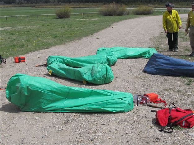  Deploying fire shelters. Photo by T.J. Hunt.