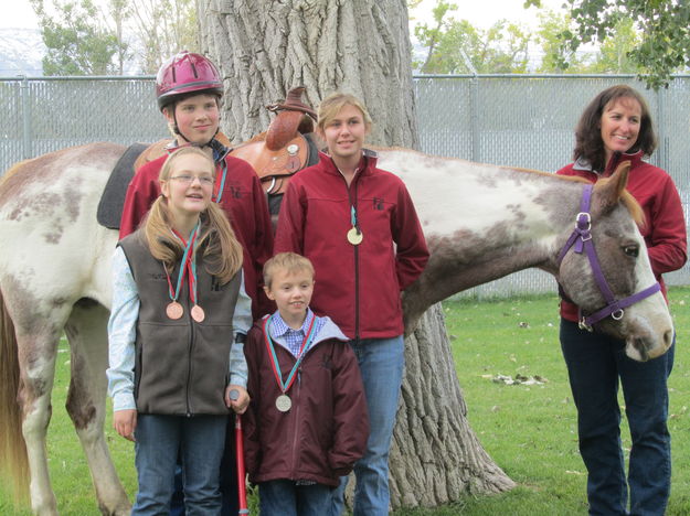 Posing with medals. Photo by M.E.S.A. Therapeutic Horsemanship, Inc..