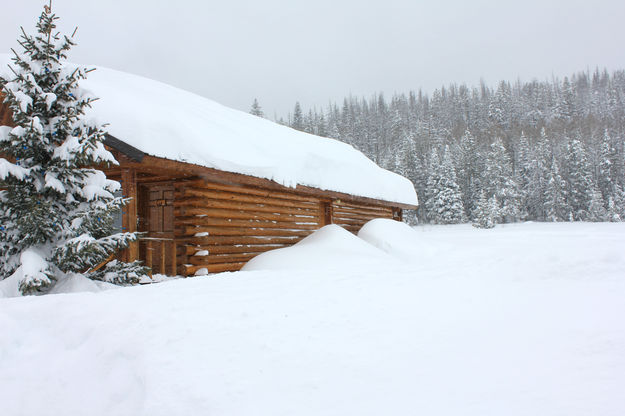 Snow up to the windows of the lodge. Photo by Kendall Valley Lodge.