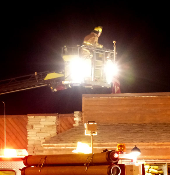 Inspecting roof. Photo by Dawn Ballou, Pinedale Online.