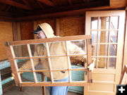 Bringing in a window. Photo by Dawn Ballou, Pinedale Online.