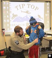 Tip Top Trainer Shawn Fits Volunteer with Float. Photo by Terry Allen.