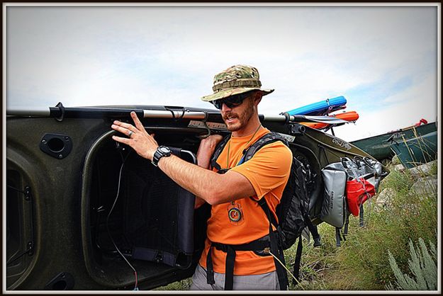 Ryan Tollison Packs His Kayak. Photo by Terry Allen.