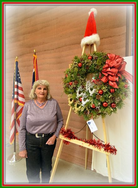 Julie Early and her wreath. Photo by Terry Allen.