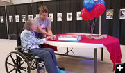 Cutting the Centennial cake. Photo by Clint Gilchrist.