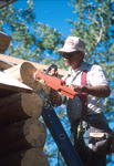 Paul Davidson works on a cabin roof.